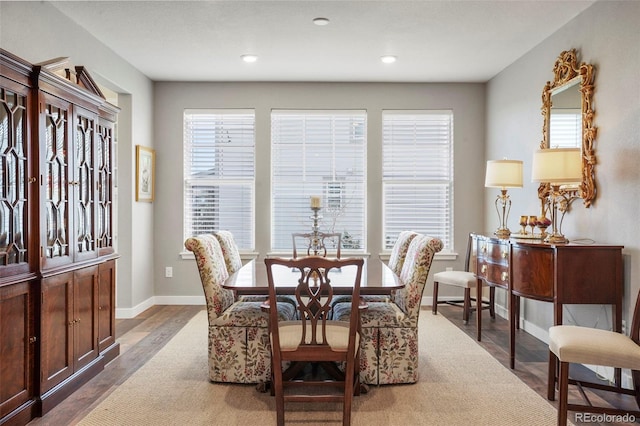 dining space featuring wood finished floors, baseboards, and recessed lighting
