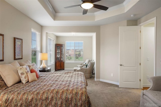 bedroom with carpet, a raised ceiling, a ceiling fan, ornamental molding, and baseboards