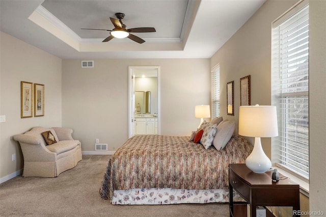 bedroom with carpet floors, multiple windows, visible vents, and a raised ceiling