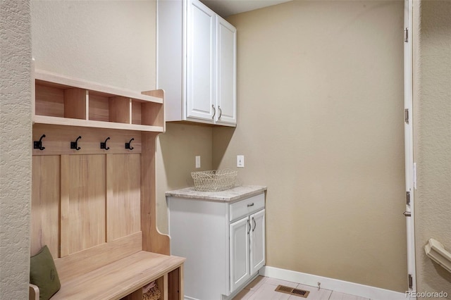 mudroom with baseboards and visible vents