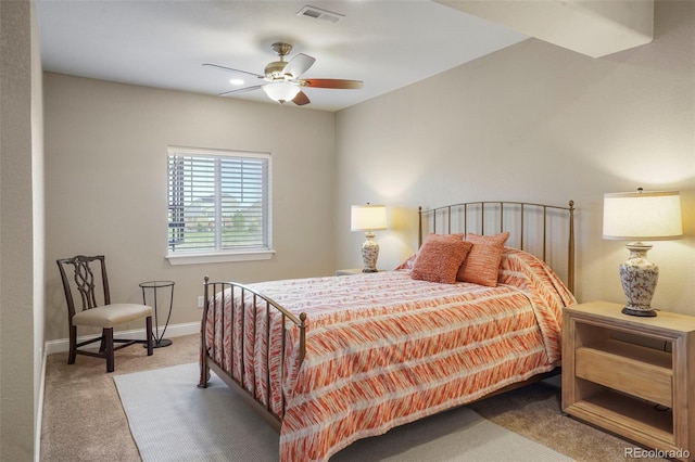 carpeted bedroom featuring baseboards, visible vents, and ceiling fan