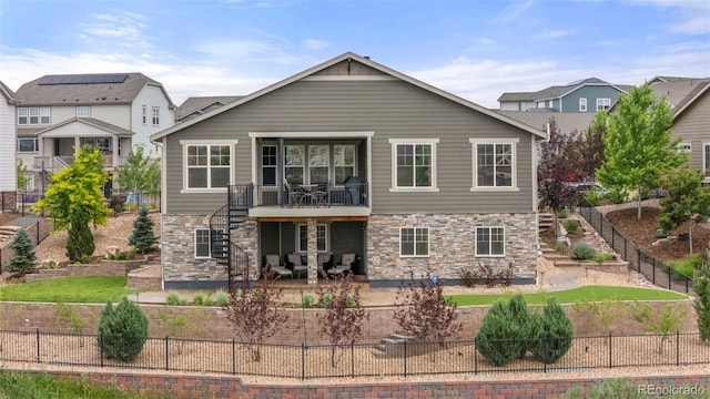7965 S Vandriver Way, Aurora, CO 80016 - back of house with a fenced backyard, a patio, and stone siding