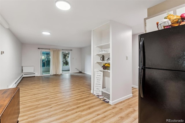 kitchen featuring black refrigerator and light hardwood / wood-style floors