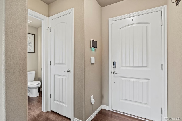9840 Castor Dr, Colorado Springs, CO 80925 - interior space featuring dark wood-style floors, a textured wall, and baseboards