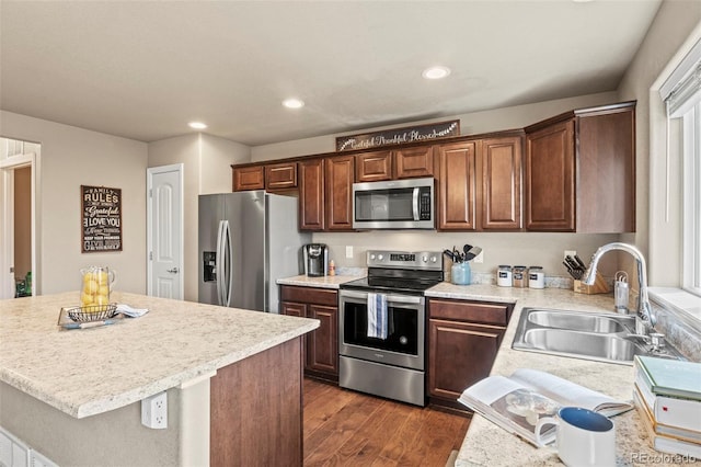 9840 Castor Dr, Colorado Springs, CO 80925 - kitchen with light countertops, recessed lighting, appliances with stainless steel finishes, a sink, and dark wood-style floors