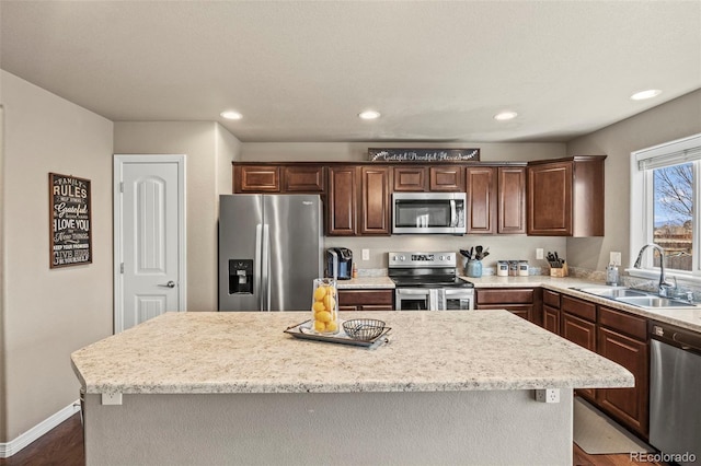 9840 Castor Dr, Colorado Springs, CO 80925 - kitchen featuring baseboards, stainless steel appliances, recessed lighting, a sink, and a center island