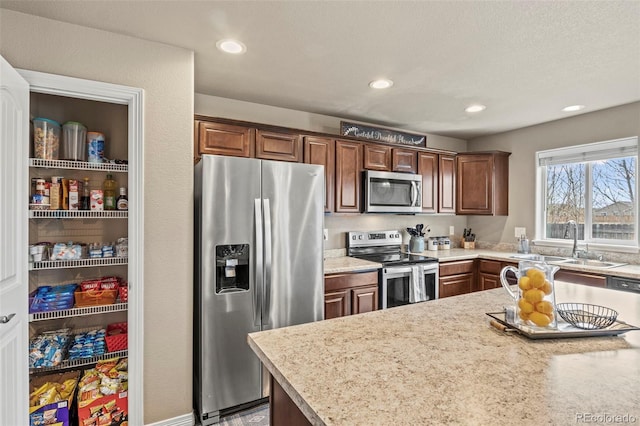 9840 Castor Dr, Colorado Springs, CO 80925 - kitchen featuring a sink, stainless steel appliances, and recessed lighting