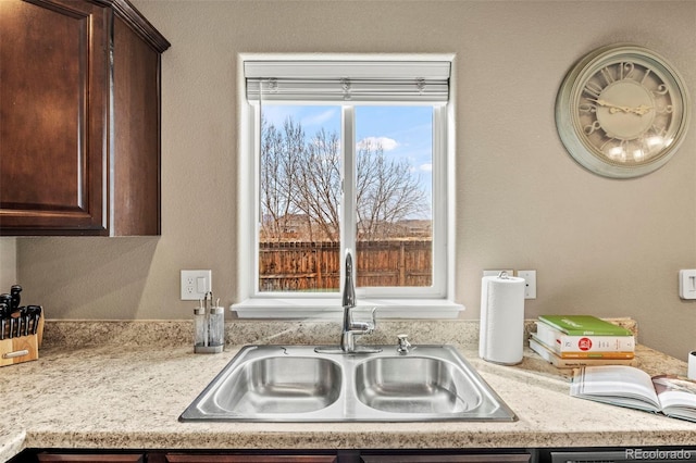 9840 Castor Dr, Colorado Springs, CO 80925 - kitchen with dark brown cabinetry and a sink