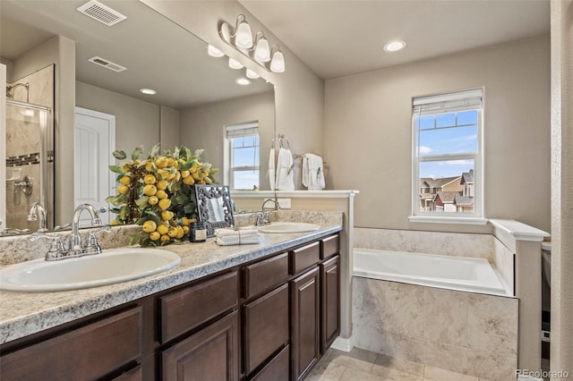 9840 Castor Dr, Colorado Springs, CO 80925 - bathroom with visible vents, a sink, and plenty of natural light