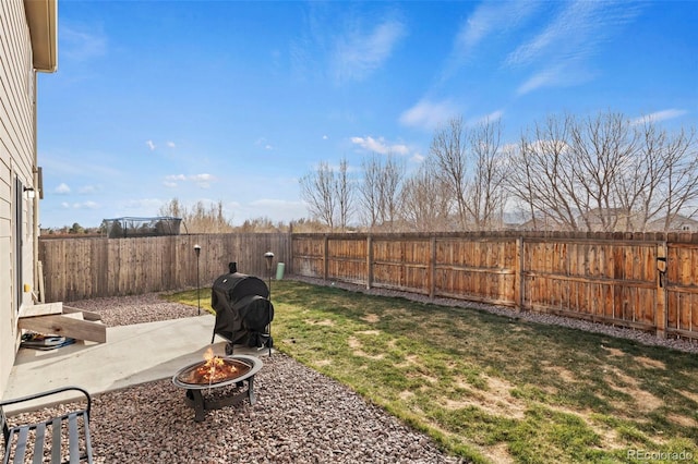 9840 Castor Dr, Colorado Springs, CO 80925 - view of yard featuring a fire pit, a fenced backyard, and a patio area
