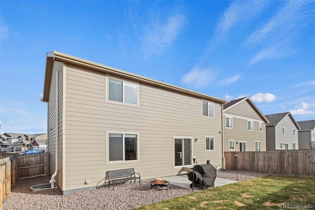 9840 Castor Dr, Colorado Springs, CO 80925 - back of house with a residential view, an outdoor fire pit, a fenced backyard, and a patio area