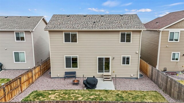 9840 Castor Dr, Colorado Springs, CO 80925 - rear view of house with a fenced backyard, a shingled roof, and a patio area
