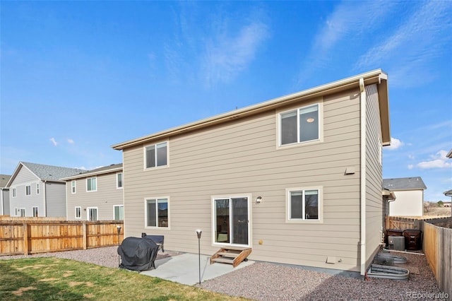 9840 Castor Dr, Colorado Springs, CO 80925 - rear view of property with cooling unit, a fenced backyard, entry steps, a patio, and a lawn