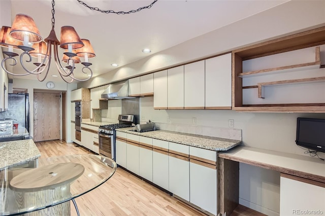 kitchen featuring white cabinetry, gas range, a chandelier, and light hardwood / wood-style flooring