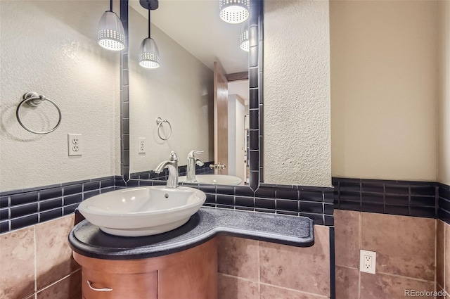 bathroom with vanity, tile walls, and tasteful backsplash