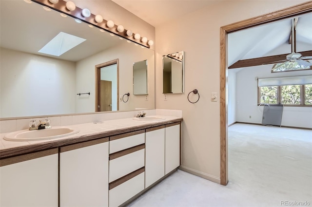 bathroom featuring vanity, a skylight, concrete floors, and ceiling fan