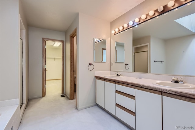 bathroom with vanity and a shower with shower door