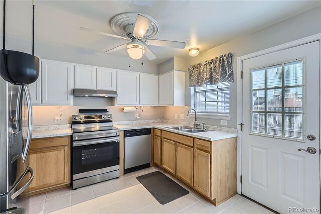 8136 Washington St Unit 141, Denver, CO 80229 - kitchen with stainless steel appliances, under cabinet range hood, a sink, and light countertops