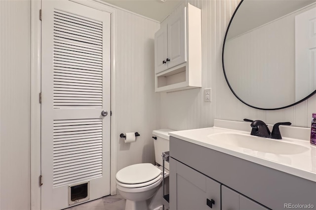 8136 Washington St Unit 141, Denver, CO 80229 - bathroom with marble look tiles, toilet, and vanity