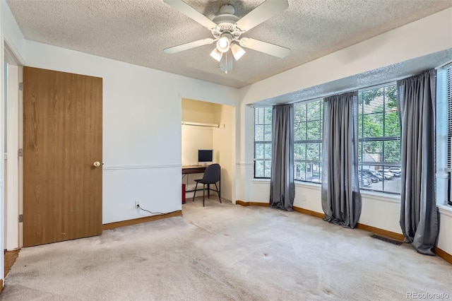 8136 Washington St Unit 141, Denver, CO 80229 - carpeted bedroom featuring a textured ceiling, an office area, baseboards, and a ceiling fan