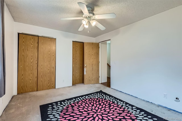 8136 Washington St Unit 141, Denver, CO 80229 - unfurnished bedroom with carpet, two closets, a textured ceiling, and ceiling fan