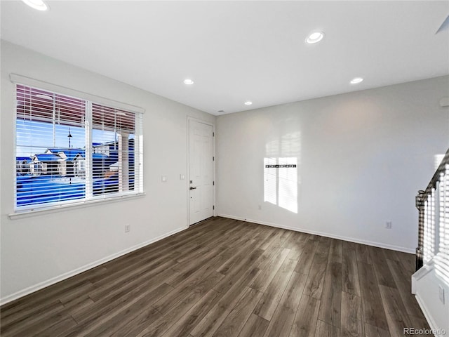 unfurnished living room with dark hardwood / wood-style floors