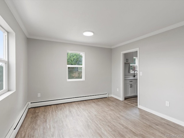 unfurnished bedroom with sink, crown molding, baseboard heating, wood-type flooring, and connected bathroom