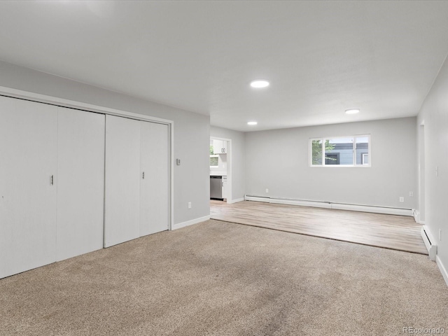 interior space featuring a baseboard radiator and light colored carpet