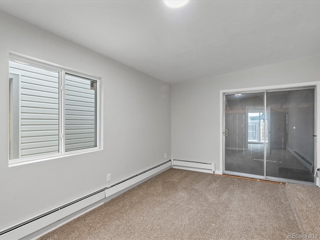 spare room with carpet and baseboard heating