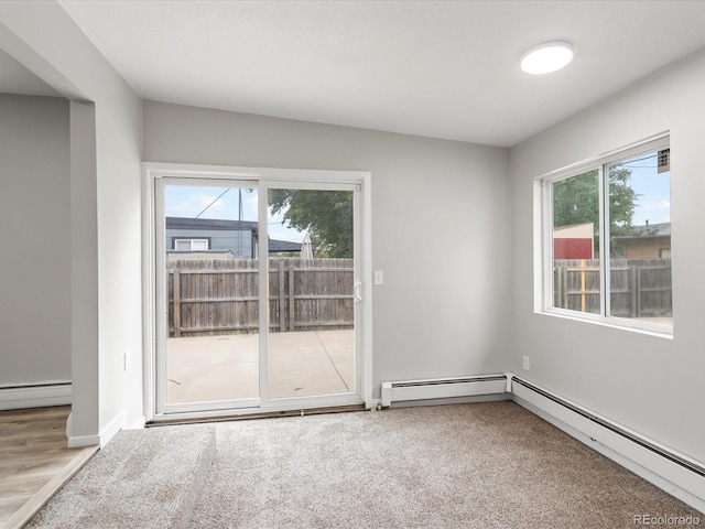 empty room featuring a baseboard radiator and wood-type flooring