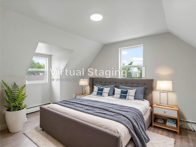 bedroom with multiple windows, hardwood / wood-style flooring, a baseboard heating unit, and lofted ceiling