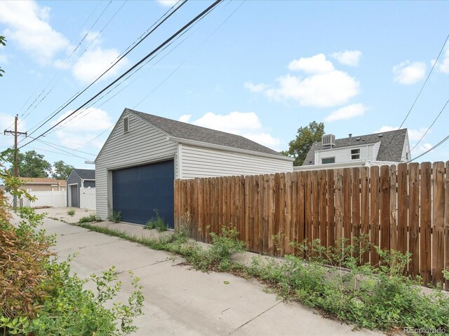 view of side of property featuring an outbuilding and a garage