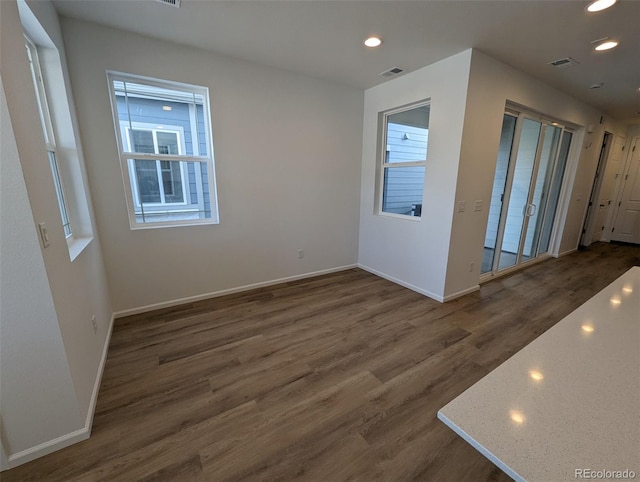 unfurnished room featuring dark hardwood / wood-style flooring