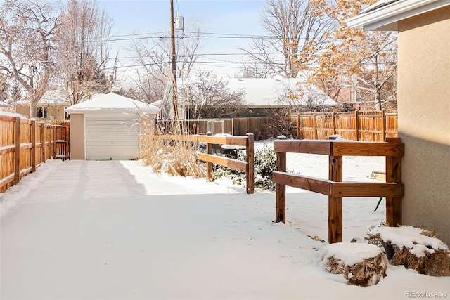 yard layered in snow with an outdoor structure