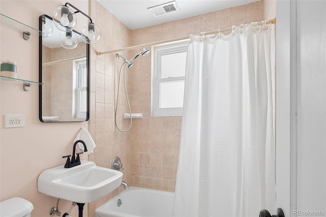 full bathroom featuring shower / bath combo, sink, and toilet