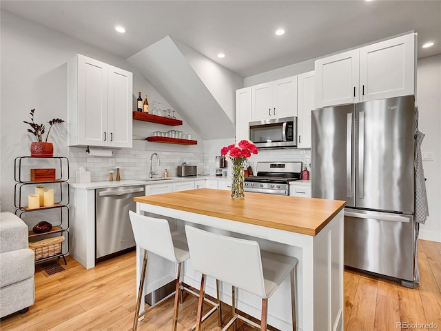 1303 Jersey St, Denver, CO 80220 - kitchen with stainless steel appliances, wood counters, a sink, light wood-style flooring, and open shelves
