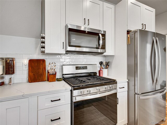 1303 Jersey St, Denver, CO 80220 - kitchen featuring stainless steel appliances, white cabinets, and backsplash