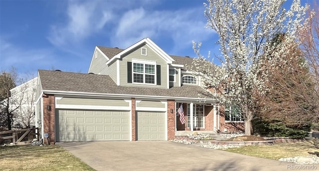 traditional-style home featuring concrete driveway, an attached garage, a shingled roof, and brick siding