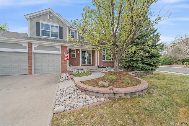 traditional-style house featuring driveway, brick siding, and a front yard