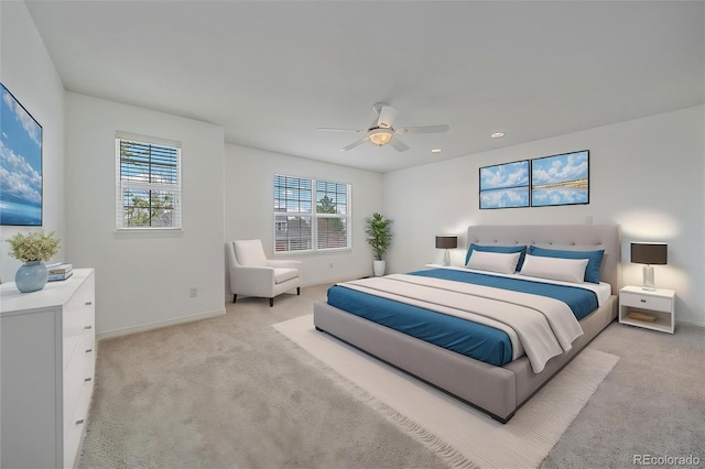 bedroom featuring light carpet, baseboards, and multiple windows