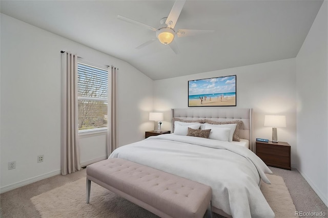 bedroom featuring vaulted ceiling, light carpet, and baseboards