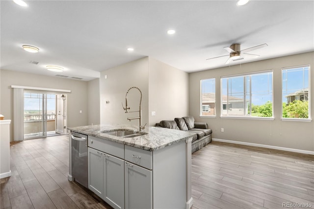 847 E 98th Ave Unit 1806, Thornton, CO 80229 - kitchen with a sink, dishwasher, light wood finished floors, baseboards, and light stone counters