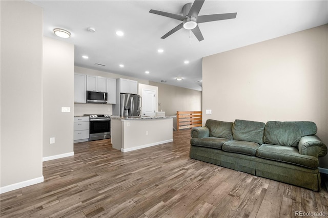 847 E 98th Ave Unit 1806, Thornton, CO 80229 - living area featuring wood finished floors, a ceiling fan, recessed lighting, and baseboards