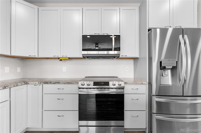 847 E 98th Ave Unit 1806, Thornton, CO 80229 - kitchen with appliances with stainless steel finishes, white cabinetry, light stone counters, and ceiling fan