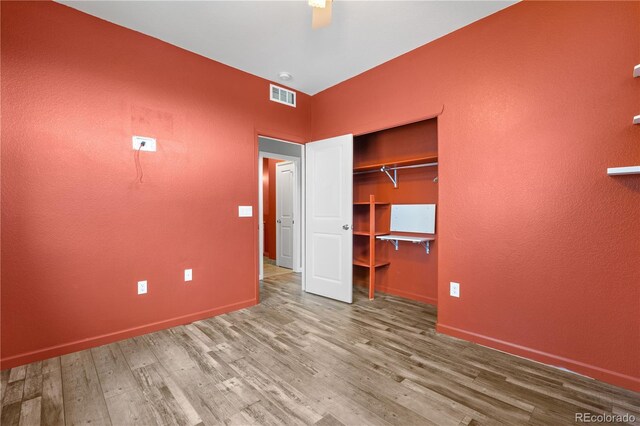 847 E 98th Ave Unit 1806, Thornton, CO 80229 - unfurnished bedroom featuring wood finished floors, baseboards, a closet, and a textured wall