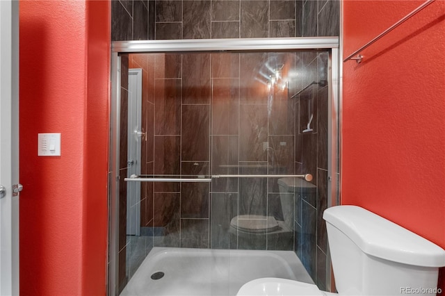 847 E 98th Ave Unit 1806, Thornton, CO 80229 - bathroom with toilet, a textured wall, and a shower stall