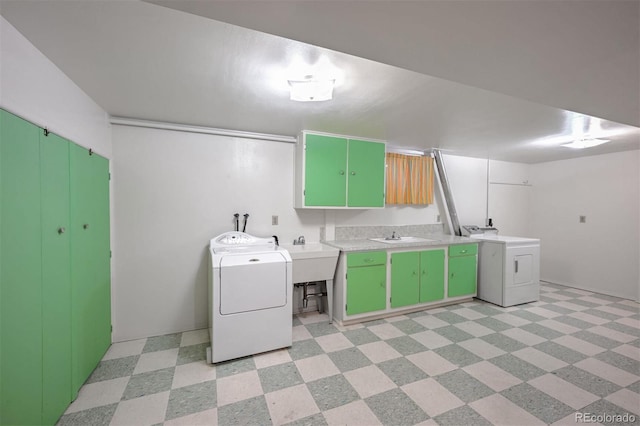 laundry area featuring cabinets, washing machine and clothes dryer, and sink