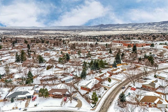 snowy aerial view featuring a mountain view