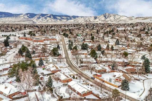 snowy aerial view with a mountain view