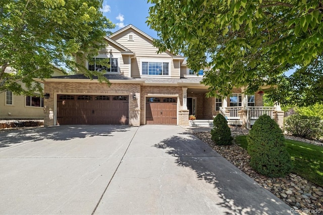 3901 Stonegrass Pt, Broomfield, CO 80023 - view of front of property with brick siding, driveway, covered porch, and a garage
